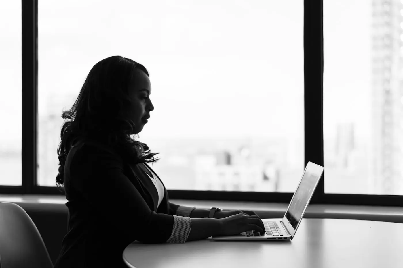 A person at a bright desk with a laptop open.